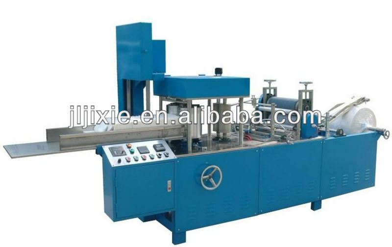 Nonwoven fabric embossing and folding machine